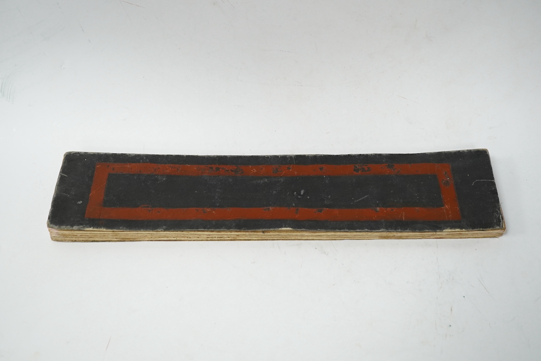 A Burmese Buddhist folding sutra with painted decoration, 40cm wide. Condition - fair